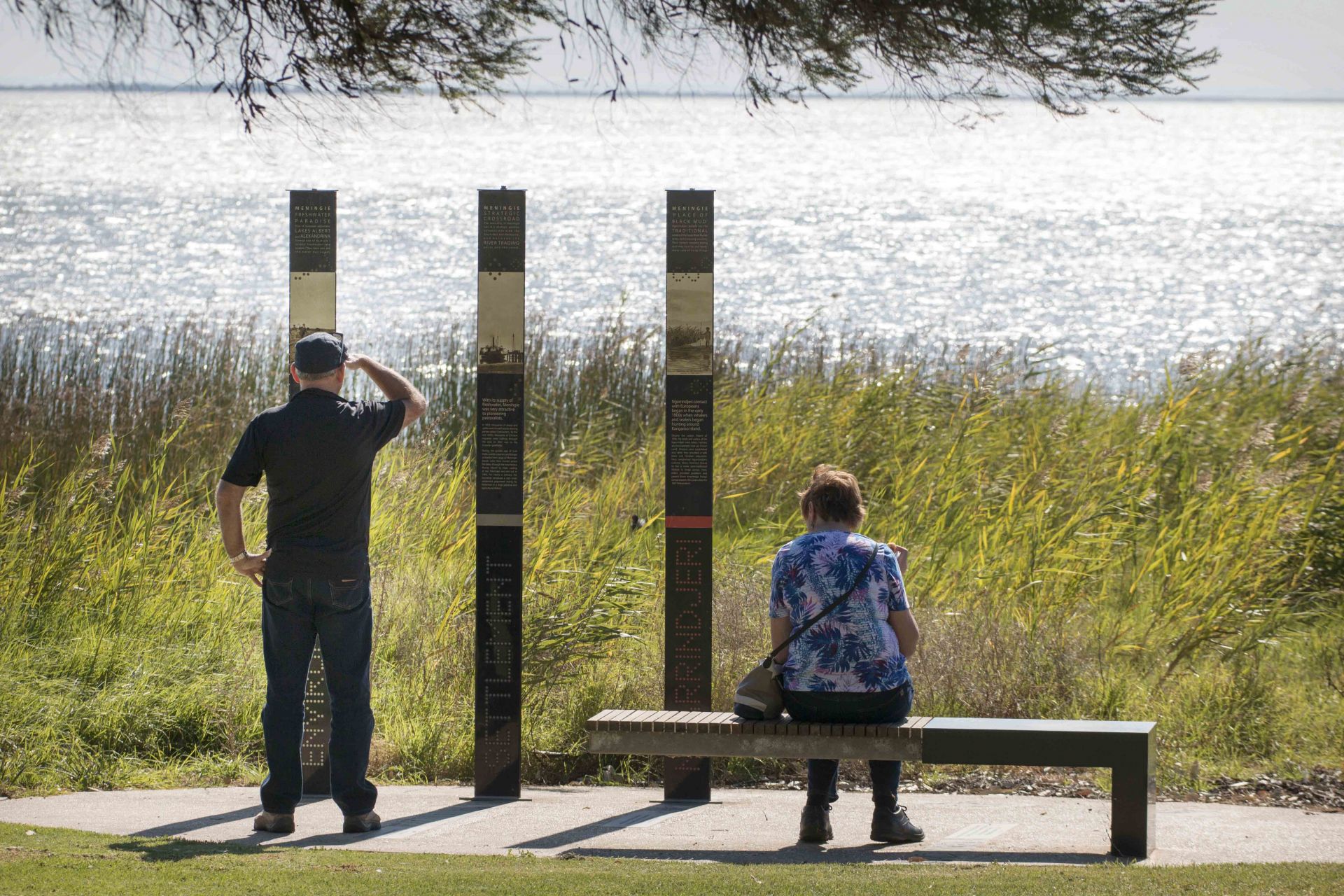 Meningie visitors looking at poles in Lions Park